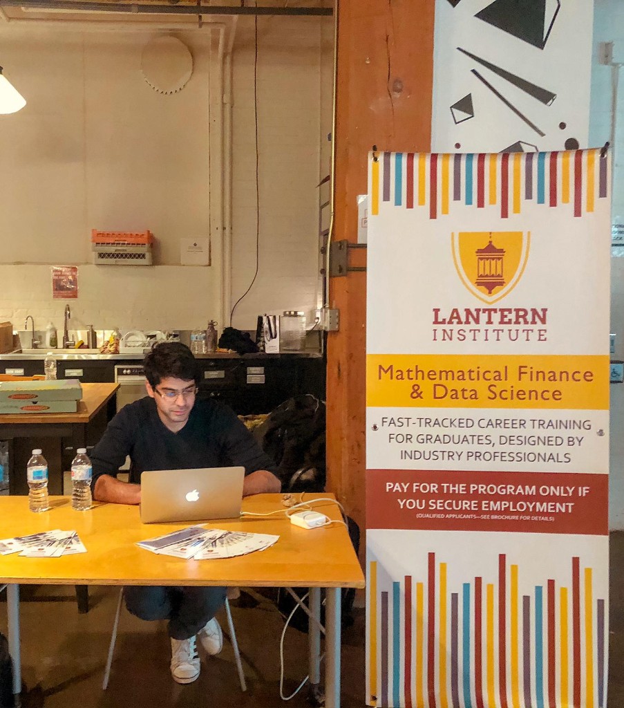 Farhad Keramati at a laptop beside a Lantern Institute banner for Mathematical Finance and Data Science.